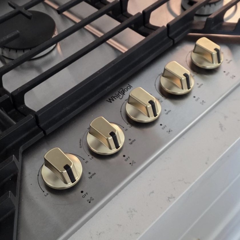 Five matte gold knobs on a Whirlpool gas cooktop (customer photo)